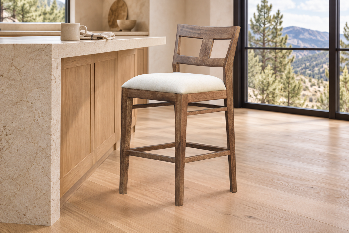 Single Tulum hardwood counter stool beside a light stone kitchen island with mountain views